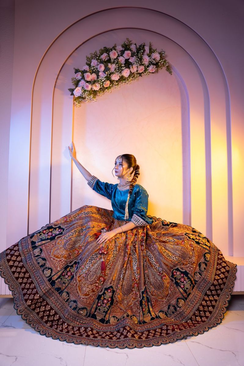 Bride in a teal and gold lehenga
