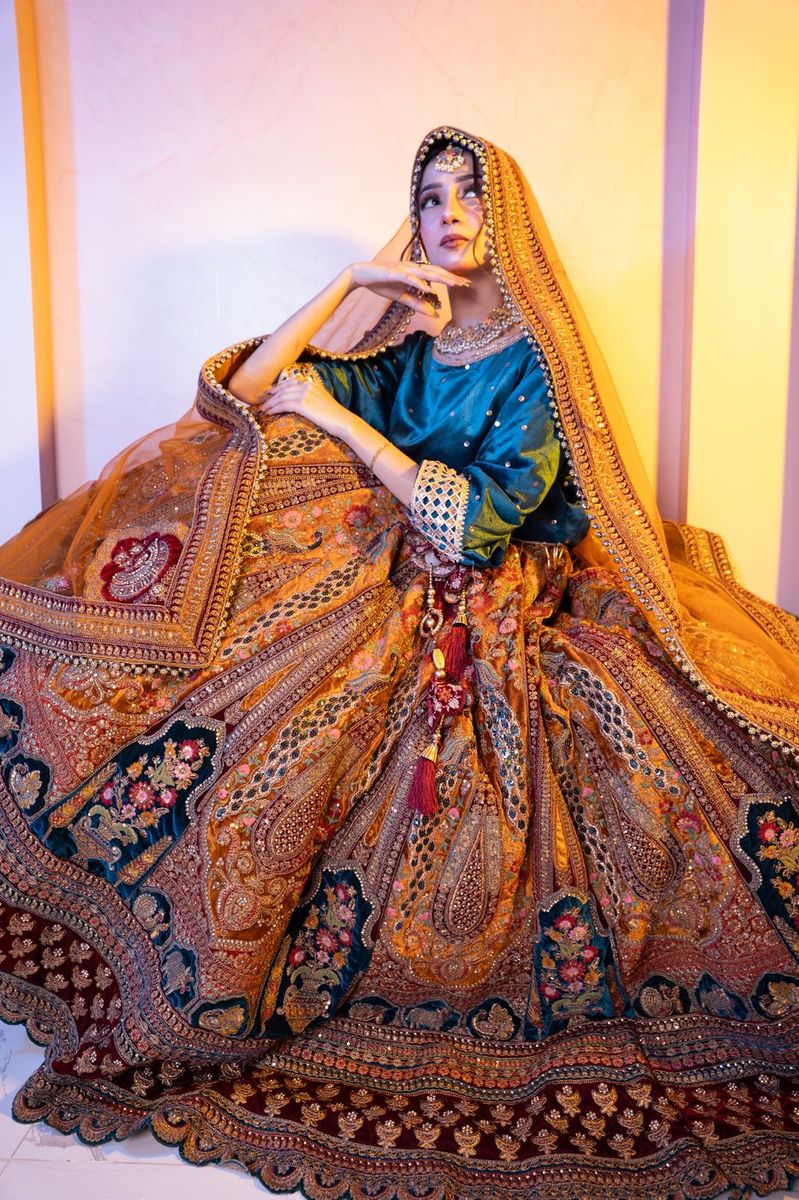 Bride in a teal and gold lehenga