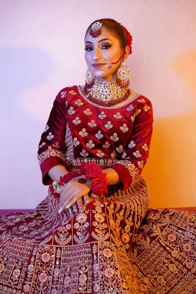 Bride in maroon velvet with gold work